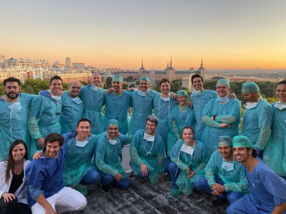 A full course group in scrubs, photographed at the end of the training